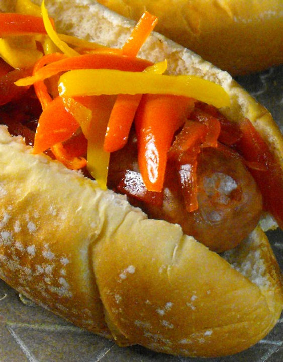 Hot dog dressed with grilled sliced peppers